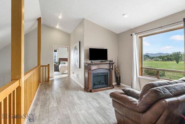 740 Linda Ln, Three Forks, MT 59752 - living area featuring lofted ceiling, light wood-style floors, and a fireplace
