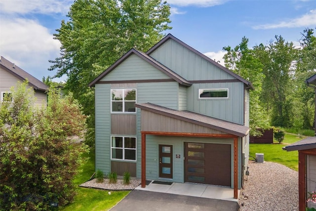 26 Locomotive Loop, Bozeman, MT 59718 - view of front facade with driveway, board and batten siding, and a front lawn