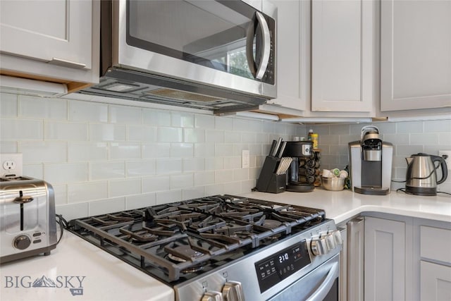 26 Locomotive Loop, Bozeman, MT 59718 - kitchen featuring stainless steel appliances, tasteful backsplash, and light countertops