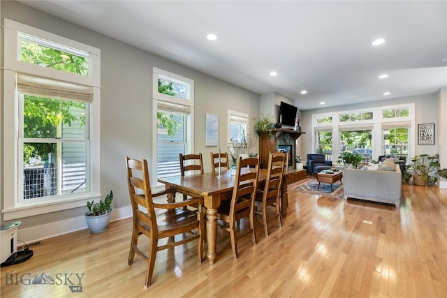 425 S Yellowstone St, Livingston, MT 59047 - dining area with healthy amount of natural light, light wood-style floors, recessed lighting, and a glass covered fireplace