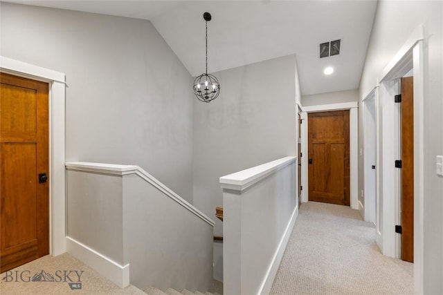 425 S Yellowstone St, Livingston, MT 59047 - hall with an upstairs landing, carpet, lofted ceiling, and a chandelier
