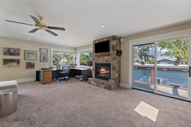 425 S Yellowstone St, Livingston, MT 59047 - carpeted office featuring a stone fireplace, plenty of natural light, a ceiling fan, and recessed lighting
