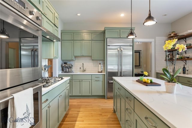 425 S Yellowstone St, Livingston, MT 59047 - kitchen featuring green cabinets, stainless steel appliances, and tasteful backsplash