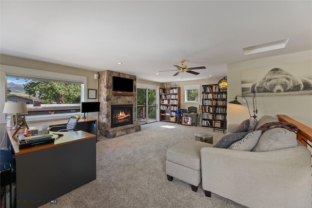 425 S Yellowstone St, Livingston, MT 59047 - carpeted living room with a stone fireplace, ceiling fan, and recessed lighting