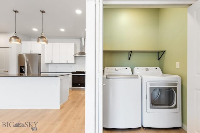 2221F Willow Unit 104, Livingston, MT 59047 - laundry area featuring independent washer and dryer, light wood-type flooring, and recessed lighting