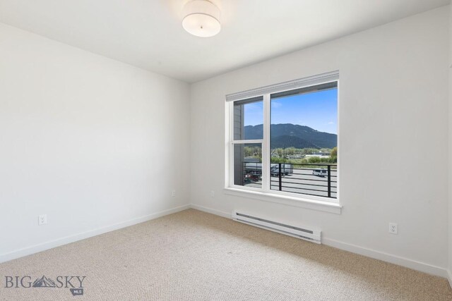 2221F Willow Unit 104, Livingston, MT 59047 - carpeted empty room featuring a baseboard radiator and a mountain view