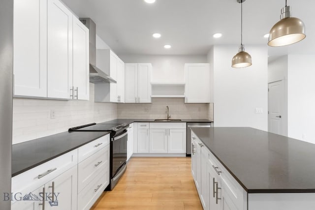 2221F Willow Unit 104, Livingston, MT 59047 - kitchen featuring range with electric stovetop, wall chimney range hood, dark countertops, open shelves, and dishwasher