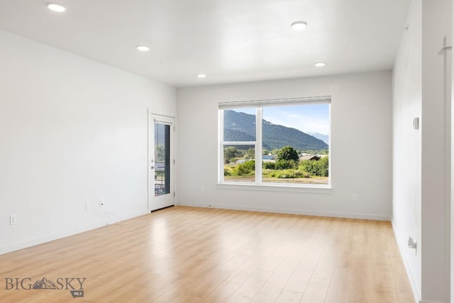 2221F Willow Unit 104, Livingston, MT 59047 - unfurnished room with a mountain view, light wood-style flooring, and recessed lighting