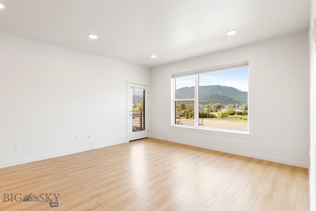 2221F Willow Unit 104, Livingston, MT 59047 - unfurnished room featuring a mountain view, recessed lighting, and light wood-style flooring