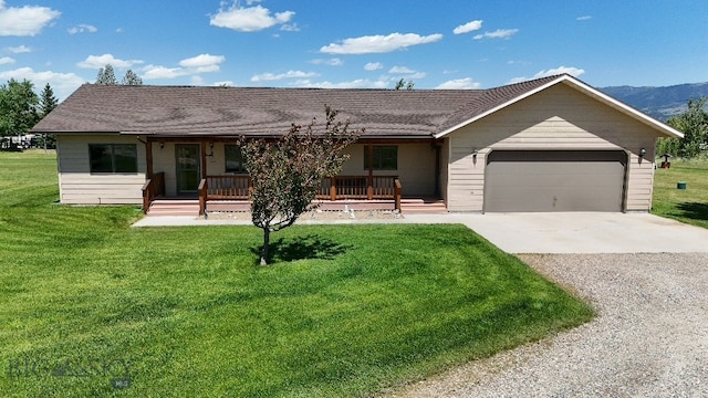 5 Ginger Quill Ct, Mcallister, MT 59740 - ranch-style house with a porch, driveway, a garage, and a front lawn