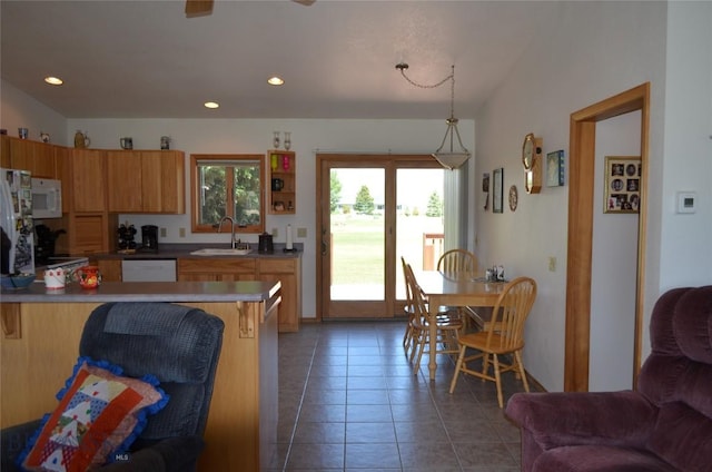 5 Ginger Quill Ct, Mcallister, MT 59740 - kitchen featuring white appliances, tile patterned floors, a peninsula, a kitchen bar, and recessed lighting