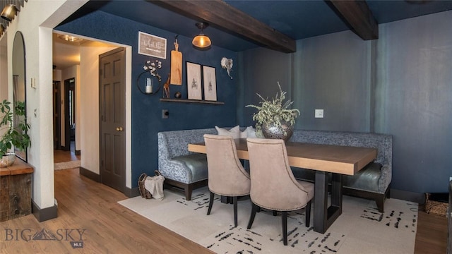 3640 Jagar Ln, Bozeman, MT 59718 - dining room featuring beam ceiling, wood finished floors, and arched walkways