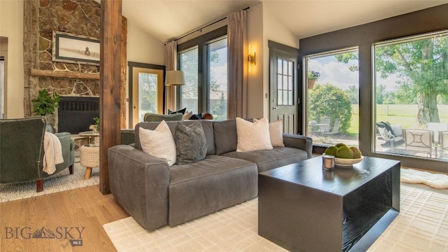 3640 Jagar Ln, Bozeman, MT 59718 - living area with plenty of natural light, lofted ceiling, light wood-style floors, and a fireplace