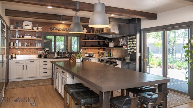 3640 Jagar Ln, Bozeman, MT 59718 - kitchen with open shelves, beam ceiling, white cabinetry, wood finished floors, and backsplash