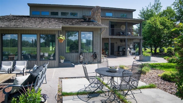 3640 Jagar Ln, Bozeman, MT 59718 - back of property featuring a balcony, a patio, and outdoor dining space