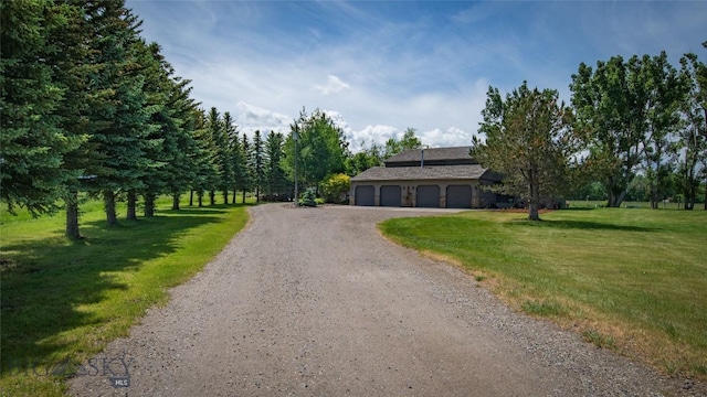 3640 Jagar Ln, Bozeman, MT 59718 - view of front facade featuring gravel driveway, a front yard, and an attached garage