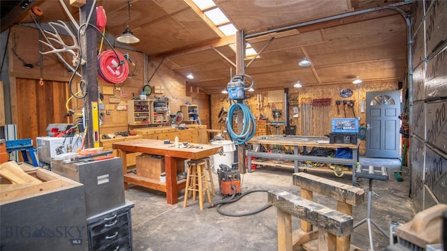 3640 Jagar Ln, Bozeman, MT 59718 - misc room featuring a workshop area, concrete flooring, and wood walls