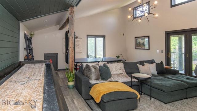 3640 Jagar Ln, Bozeman, MT 59718 - living room featuring plenty of natural light, wood finished floors, vaulted ceiling, and a chandelier
