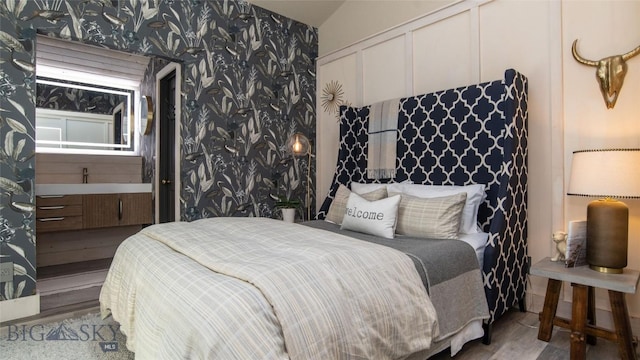 3640 Jagar Ln, Bozeman, MT 59718 - bedroom featuring wallpapered walls, wood finished floors, and vaulted ceiling