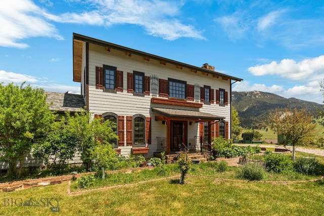 250 Silver Run Rd, Gallatin Gateway, MT 59730 - view of front facade featuring a chimney, a mountain view, and a front yard