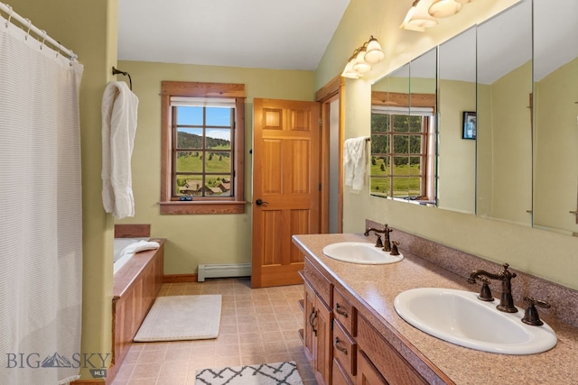 250 Silver Run Rd, Gallatin Gateway, MT 59730 - bathroom featuring baseboard heating, healthy amount of natural light, double vanity, and a garden tub