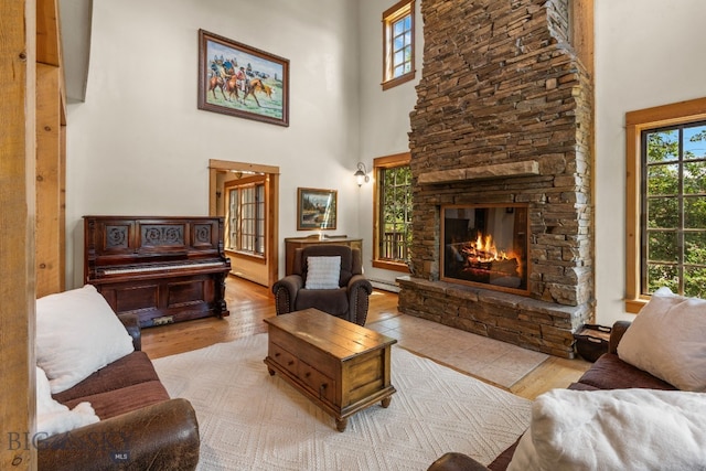 250 Silver Run Rd, Gallatin Gateway, MT 59730 - living area with a towering ceiling, healthy amount of natural light, a fireplace, and wood finished floors