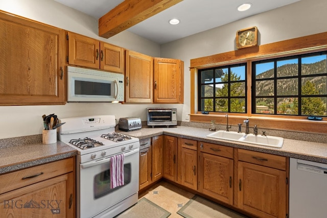 250 Silver Run Rd, Gallatin Gateway, MT 59730 - kitchen with white appliances, beam ceiling, brown cabinets, and recessed lighting
