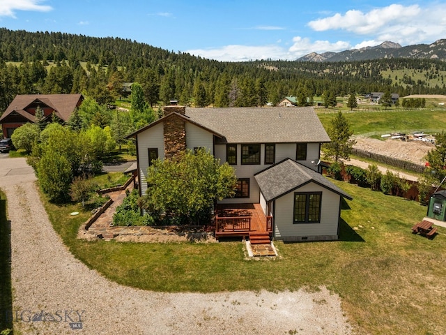 250 Silver Run Rd, Gallatin Gateway, MT 59730 - view of front of property featuring a view of trees, a chimney, a deck with mountain view, roof with shingles, and a front yard