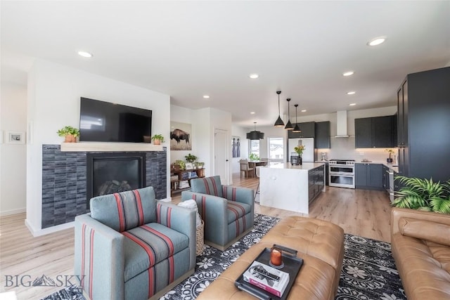 3083 S 27th Ave, Bozeman, MT 59718 - living area featuring light wood-style flooring, recessed lighting, and a tiled fireplace