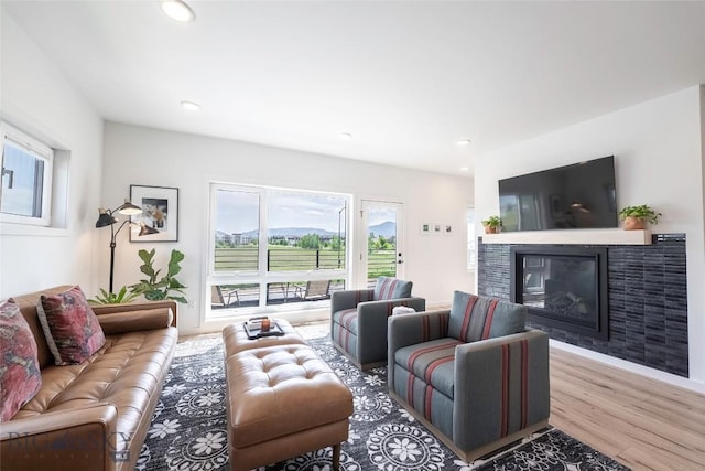3083 S 27th Ave, Bozeman, MT 59718 - living area with a glass covered fireplace, wood finished floors, and recessed lighting