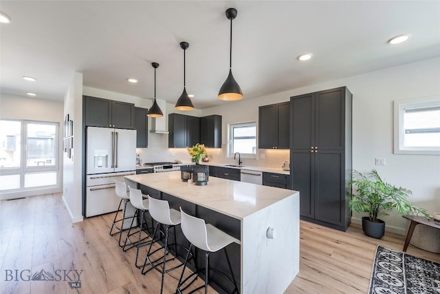 3083 S 27th Ave, Bozeman, MT 59718 - kitchen featuring white appliances, a kitchen bar, light stone countertops, a kitchen island, and backsplash