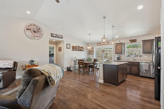 444 Highpark, Anaconda, MT 59711 - kitchen featuring appliances with stainless steel finishes, open floor plan, lofted ceiling, a breakfast bar area, and dark wood-style flooring