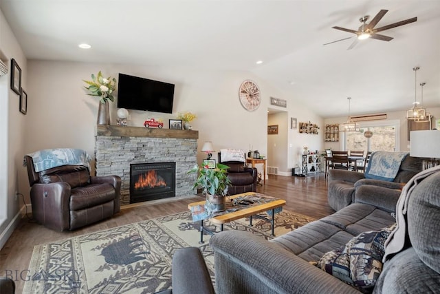 444 Highpark, Anaconda, MT 59711 - living area with vaulted ceiling, ceiling fan, a stone fireplace, and wood finished floors