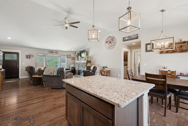 444 Highpark, Anaconda, MT 59711 - kitchen with ceiling fan, dark wood-type flooring, a stone fireplace, hanging light fixtures, and recessed lighting