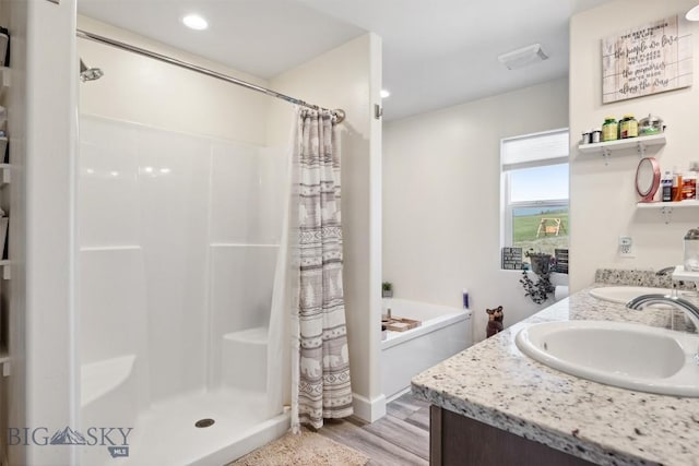 444 Highpark, Anaconda, MT 59711 - bathroom featuring a stall shower, double vanity, wood finished floors, a bath, and recessed lighting