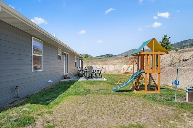 444 Highpark, Anaconda, MT 59711 - view of grassy yard featuring a playground, a mountain view, and a patio