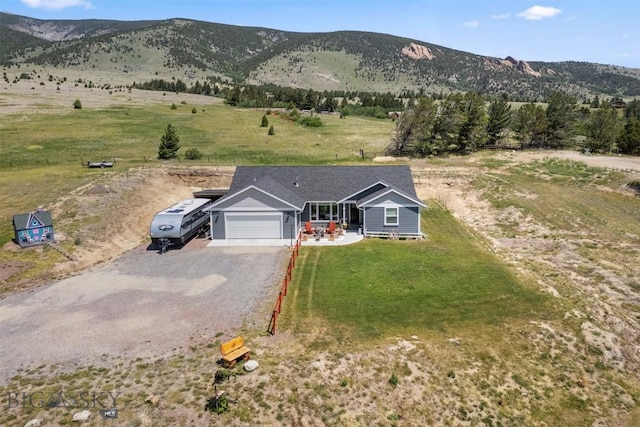 444 Highpark, Anaconda, MT 59711 - view of front of home featuring a garage, gravel driveway, a mountain view, a front yard, and a rural view