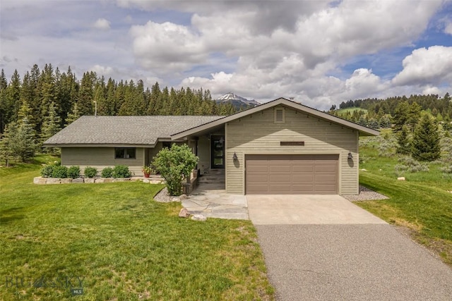 17 Chief Joseph Trl, Big Sky, MT 59716 - view of front of home with driveway, an attached garage, a front lawn, and a forest view