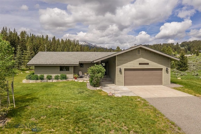 17 Chief Joseph Trl, Big Sky, MT 59716 - view of front of property featuring driveway, an attached garage, and a front lawn