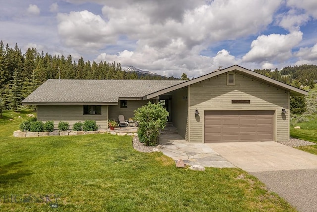 17 Chief Joseph Trl, Big Sky, MT 59716 - view of front facade with concrete driveway, a garage, and a front lawn