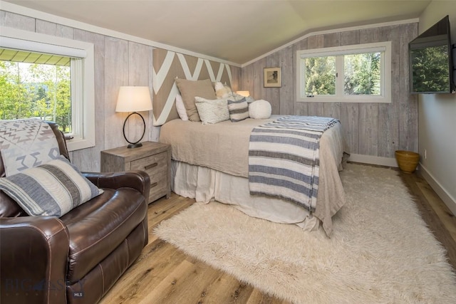 17 Chief Joseph Trl, Big Sky, MT 59716 - bedroom featuring wood finished floors, vaulted ceiling, and wood walls