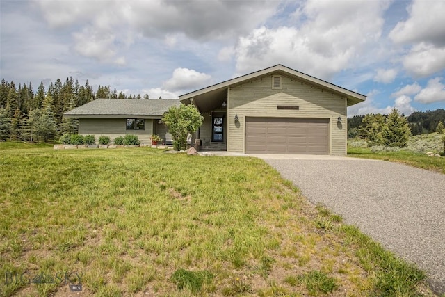 17 Chief Joseph Trl, Big Sky, MT 59716 - view of front facade with driveway, a front lawn, and an attached garage