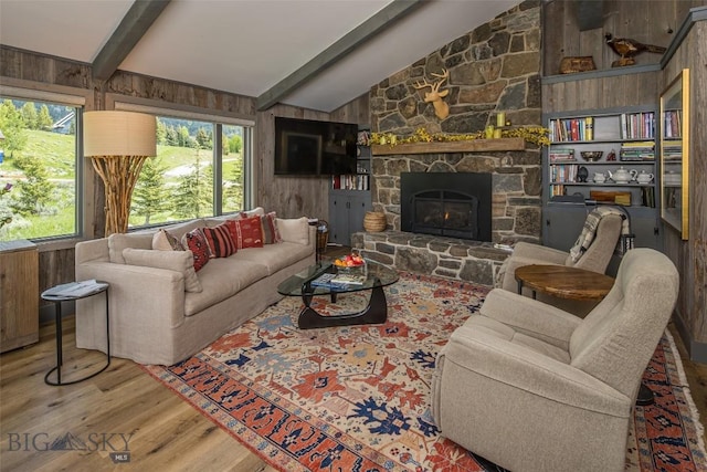 17 Chief Joseph Trl, Big Sky, MT 59716 - living area with wood finished floors, wooden walls, and a stone fireplace