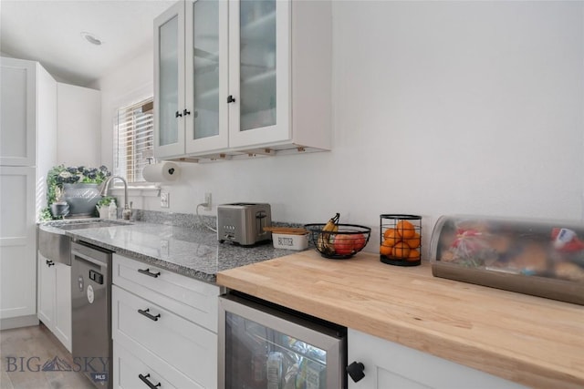 217 Lillian Way, Bozeman, MT 59718 - kitchen with beverage cooler, dishwasher, glass insert cabinets, white cabinets, and butcher block countertops