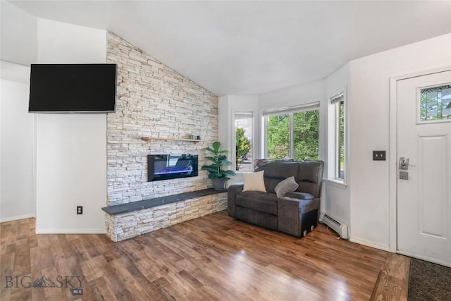 217 Lillian Way, Bozeman, MT 59718 - living room with a baseboard radiator, a fireplace, wood finished floors, and high vaulted ceiling