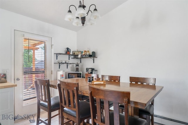 217 Lillian Way, Bozeman, MT 59718 - dining room featuring a baseboard radiator, a chandelier, and lofted ceiling