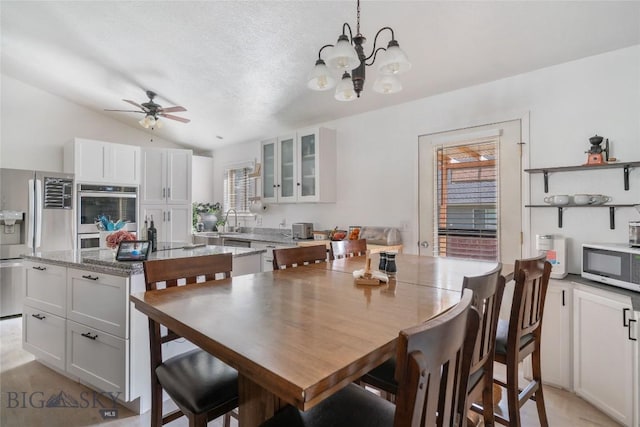 217 Lillian Way, Bozeman, MT 59718 - dining space with vaulted ceiling, a ceiling fan, and a chandelier