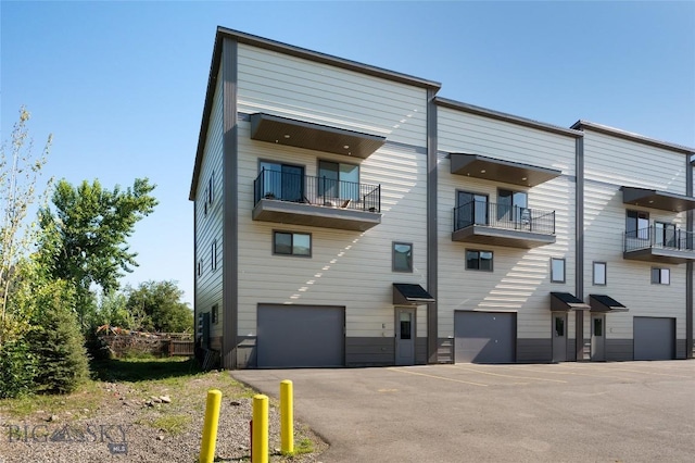 223 New Ventures Dr, Bozeman, MT 59718 - view of building exterior featuring an attached garage and driveway