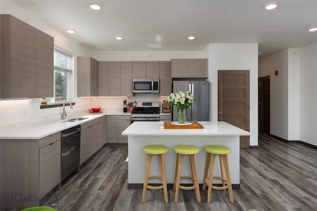 223 New Ventures Dr, Bozeman, MT 59718 - kitchen featuring stainless steel appliances, modern cabinets, a center island, dark wood-style floors, and a breakfast bar