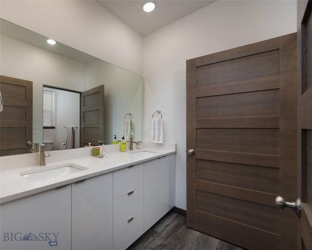 223 New Ventures Dr, Bozeman, MT 59718 - bathroom featuring double vanity, wood finished floors, and recessed lighting